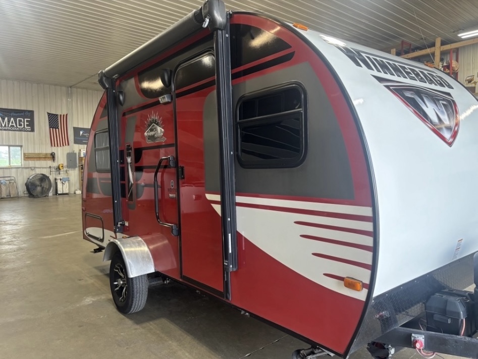 Restored deep red Winnebago travel trailer after restoration
