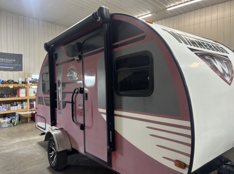 Faded pink Winnebago travel trailer before restoration