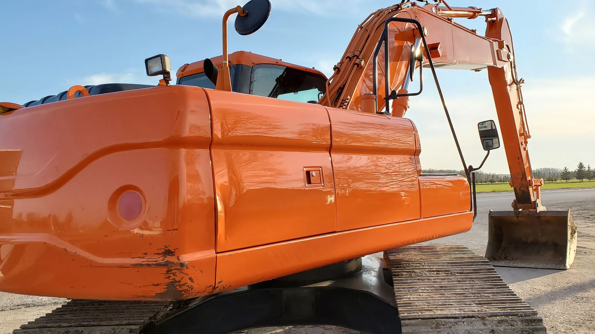 Restored glossy orange excavator after restoration