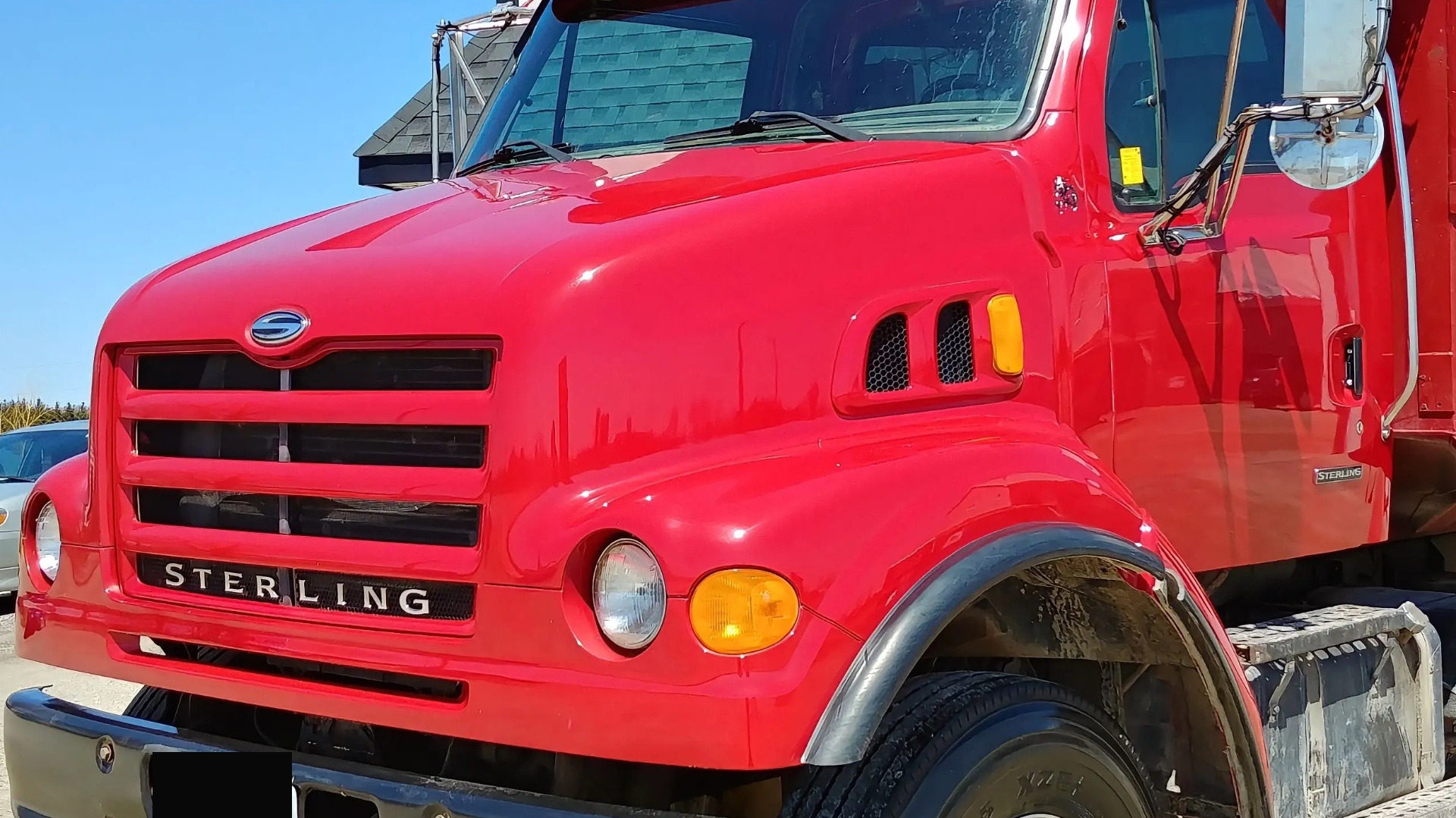 Restored glossy yellow Sterling dump truck after restoration